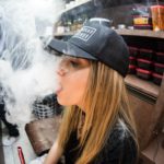 Beautiful woman using vape